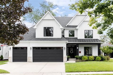 white house with dark metal windows|black trim with white windows.